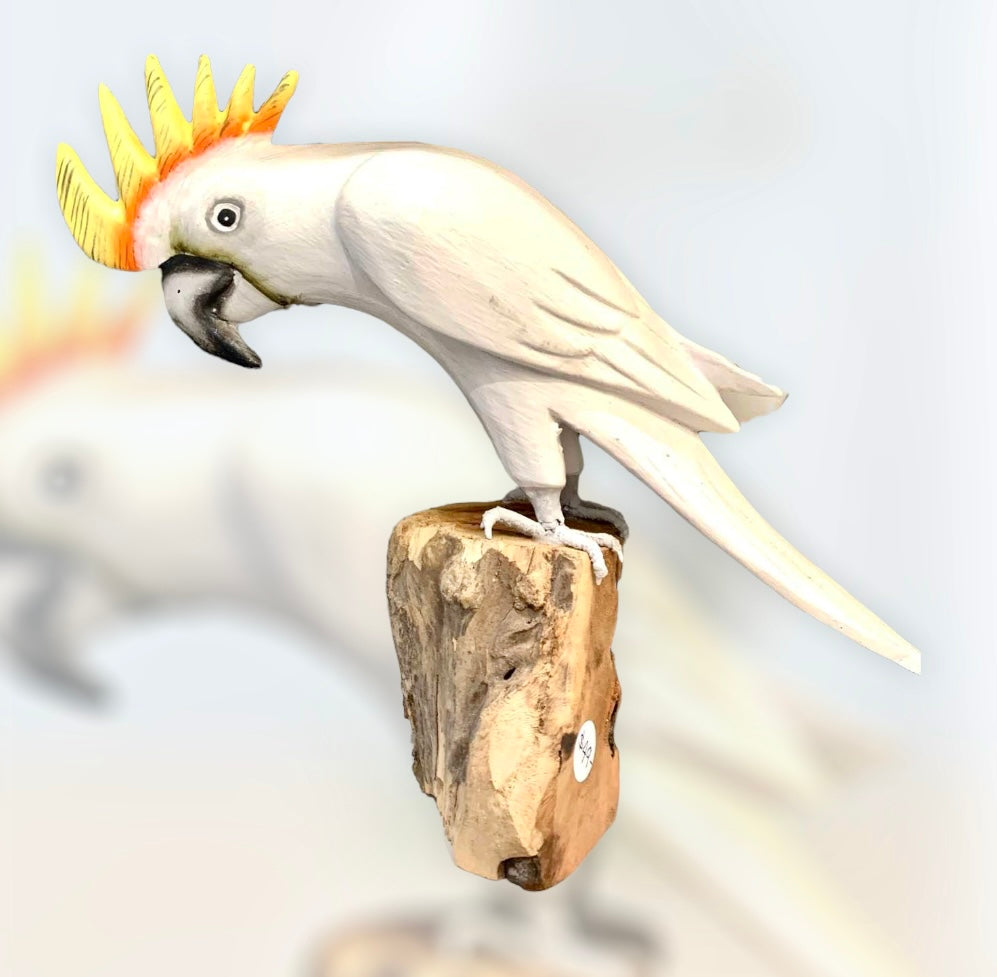 Wooden cockatoo on a log